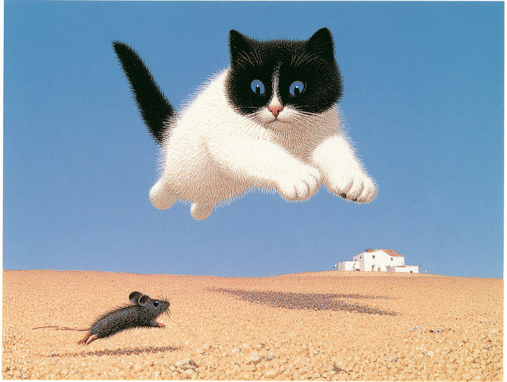 White cat with a black head leaping through a blue sky above a mouse on desert sand
